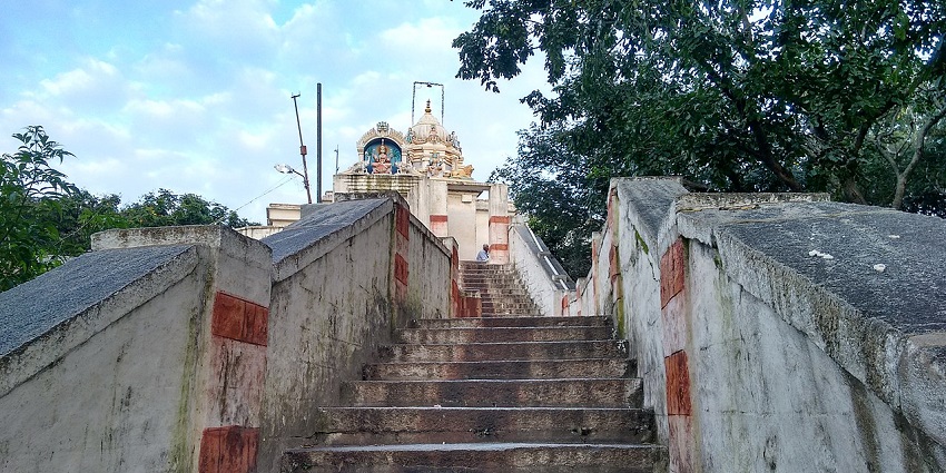 A picture of a temple's staircase leading to the interiors of the temple having idols of deities