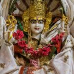 Parshvanath Devi temple - Close-up of a white and gold Maa Padmavati in traditional attire.