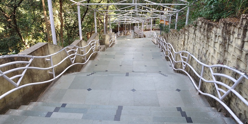 Stairway leading to Pahari Mandir on Ranchi Hill and surrounded by boundary and trees