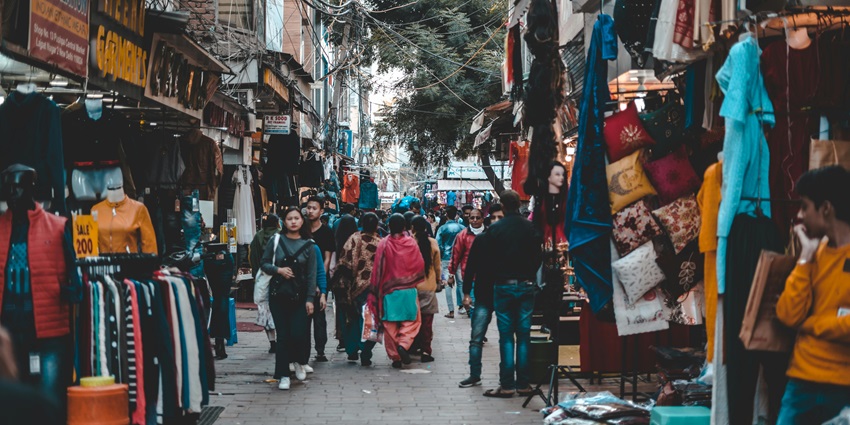 An image of Palika Bazaar featuring shoppers exploring bargain clothing and accessories.