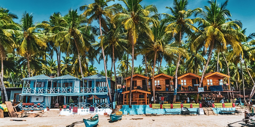 Enjoy a silent disco party at Palolem Beach in Goa, with people dancing in headphones.