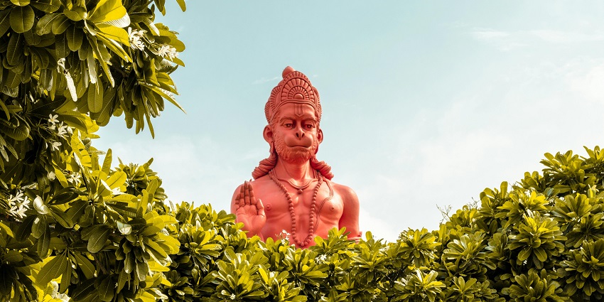 Beautiful image of the Bhagwan hanuman and his giant statue behind the lush trees