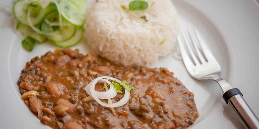 Punjabi-style dal makhani served in a bowl with a rich, creamy texture and garnished with herbs