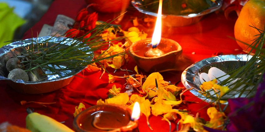 Image of pooja thali with a diya on it and other things for pooja rituals displayed