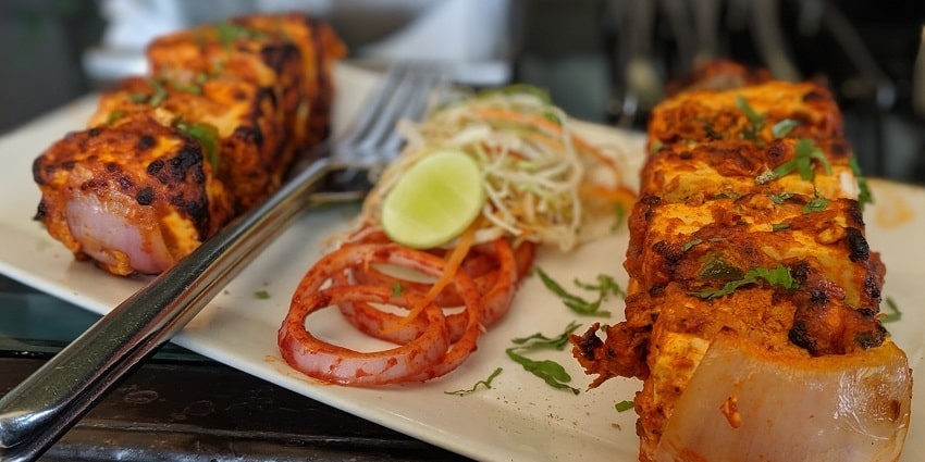 Paneer tikka served with mint and spicy red chutney is a ideal snack for spicy food lovers