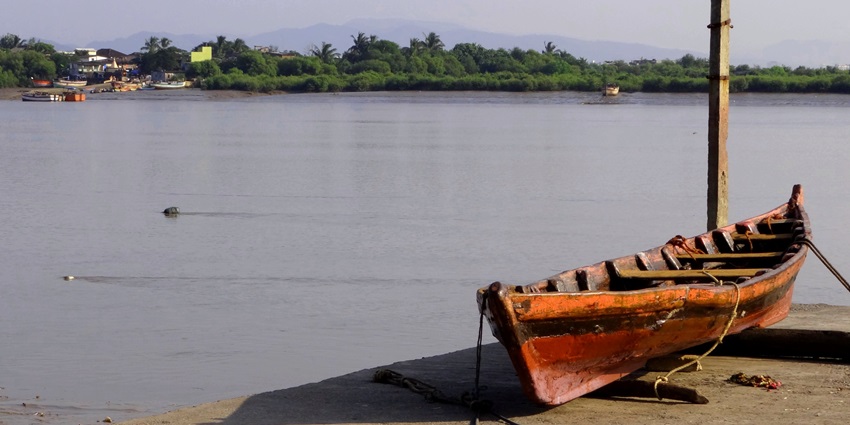 A scenic view of the Panju Island surrounded by cobalt blue waters featuring a boat.