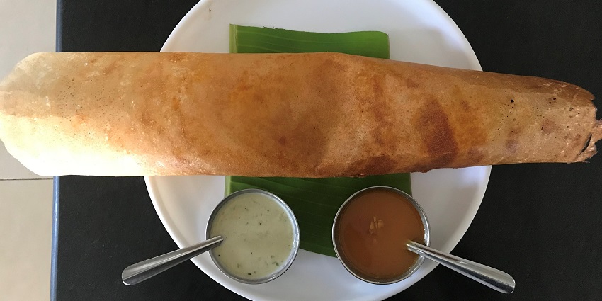 Masala dosa served with sambhar and coconut chutney