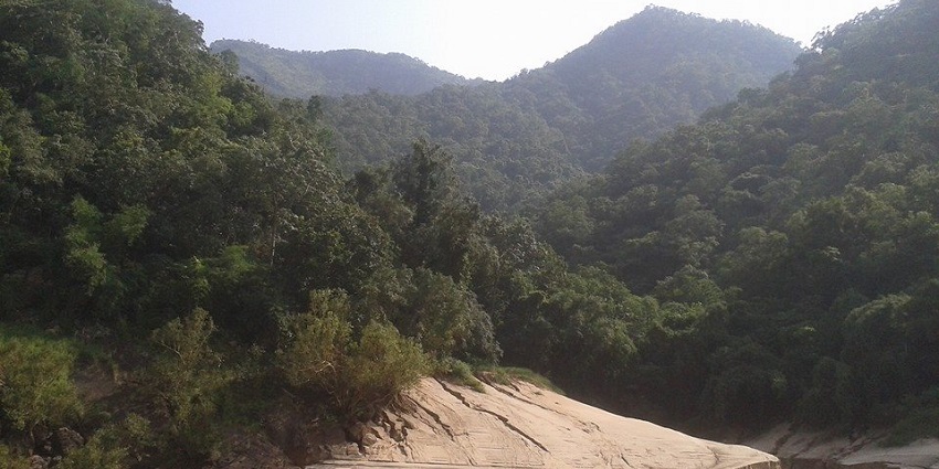 Image of Papikonda National Park with lush greenery covered hills near body of water
