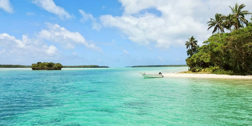 A scenic view of Paradise Beach featuring shimmering blue lagoons and golden sands.