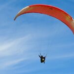 A person paragliding through the beauty of the town and moist mist - paragliding in Gujarat