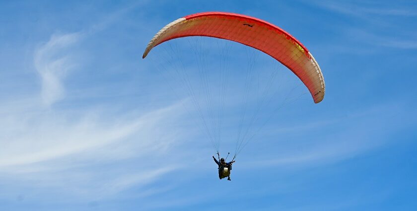 A person paragliding through the beauty of the town and moist mist - paragliding in Gujarat