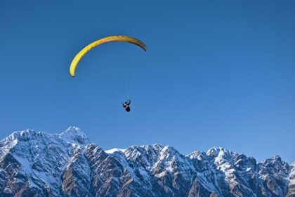 Experience paragliding in Khajjiar soaring over the lush green meadows of Himachal Pradesh.