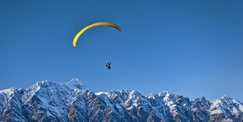 Experience paragliding in Khajjiar soaring over the lush green meadows of Himachal Pradesh.