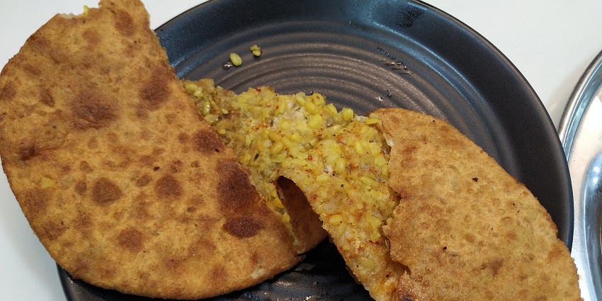 Image of delicious daal paratha in Parathe wale gali served with achar and dahi on the side