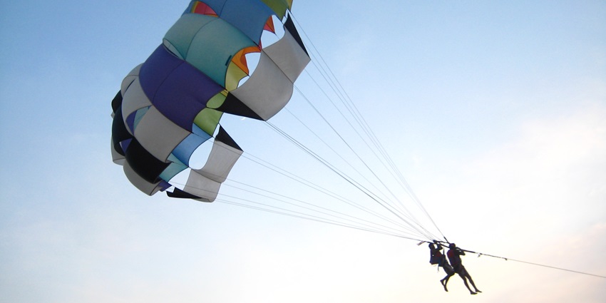 A person parasailing, one of the popular Calangute Beach water sports in Goa.