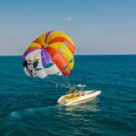 A mindblowing view of a motorboat attached to a parachute for an adventurous activity.