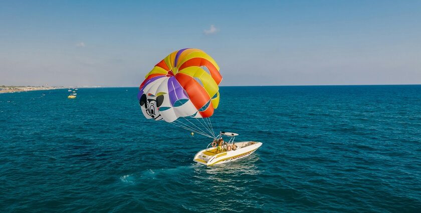 A mindblowing view of a motorboat attached to a parachute for an adventurous activity.