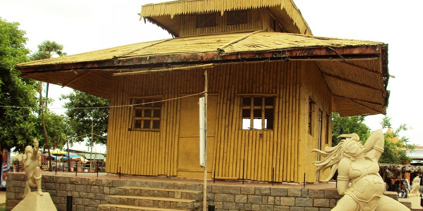A picture of a hut-like temple in Bhadrachalam with a sculpture of a dancing lady outside