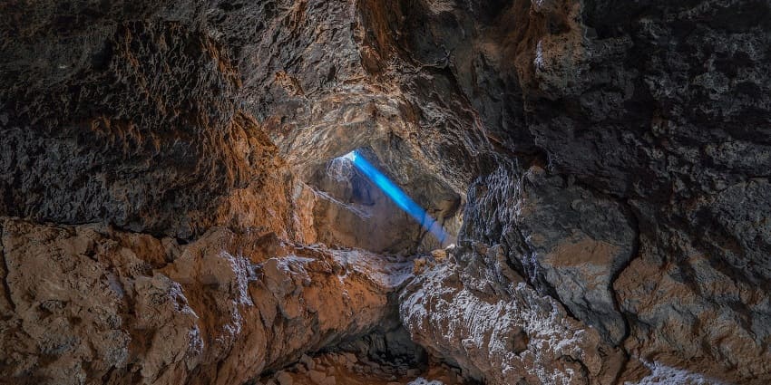 Sunbeam illuminating a cave, echoing the serene Shree Parshuram Mahadev Cave Temple.