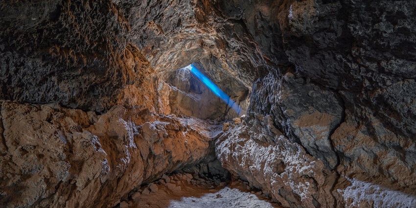 A sunbeam lights up the tranquil Parshuram Cave Temple, creating a perfect serene view