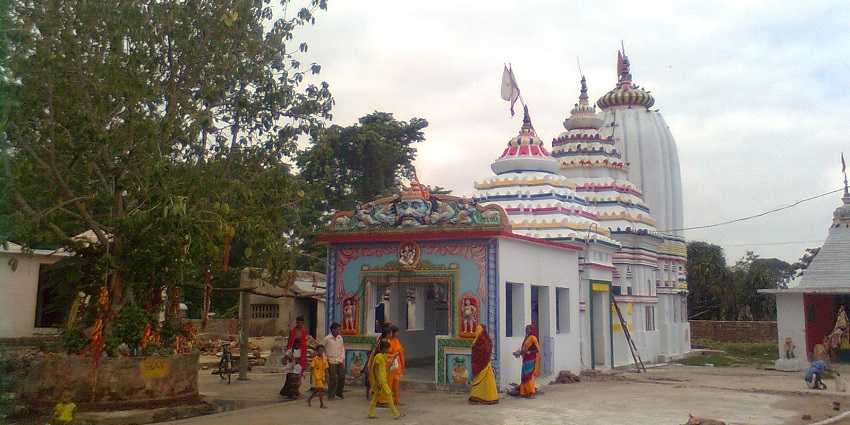 Outside the Siddheswar Baba temple and a sacred tree in view with local people around it.
