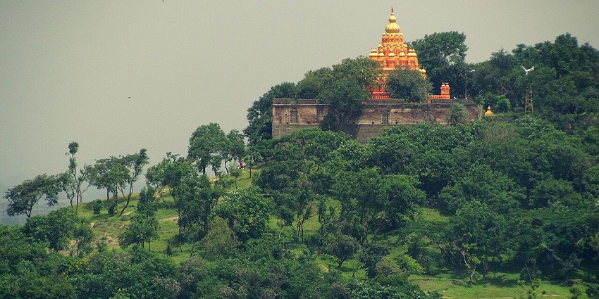 Serene Shiva temple on a panoramic hill, ideal for trekking and relaxation.