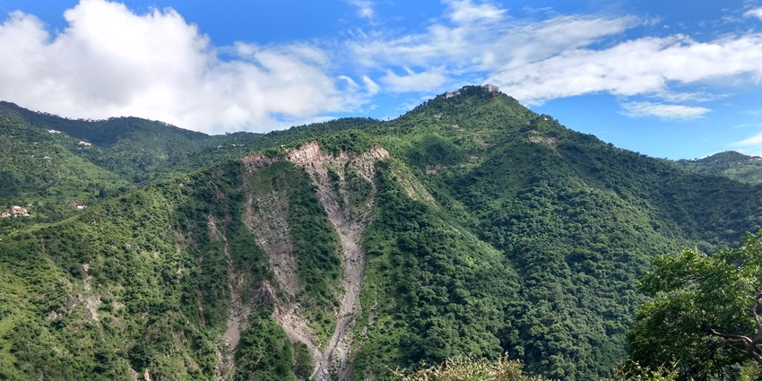 Picturesque view of Parwanoo Hills surrounded by lush green mountains under clear sky