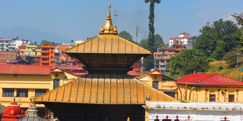 Pashupatinath Temple, with beautiful architecture, surrounded by buildings.