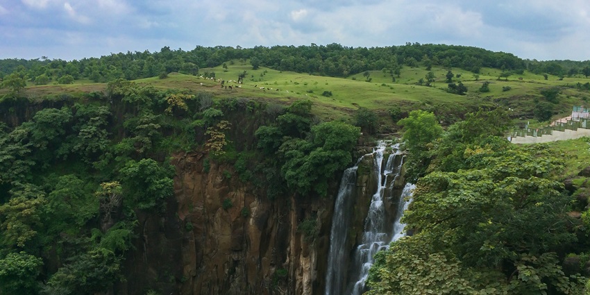 View of Patalpani Waterfalls, a famous place near Annapurna Temple, capturing the cascading water and lush green surroundings.