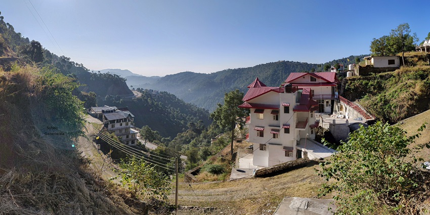 A panoramic view of the serene village of Patkote, covered under a blanket of lush greenery