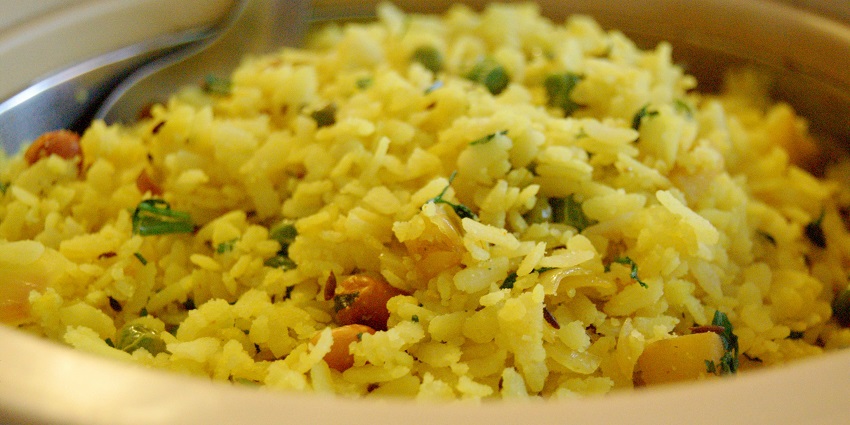 A closer look at Poha garnished with fried peanuts, one of the best foods in Ahmedabad.