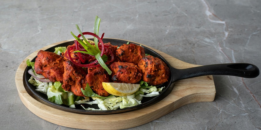 Traditional North Indian dining experience at Peshawri serving chicken tandoori dishes.