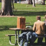 Image of a couple sitting on bench with picnic basket - one day picnic place near Ahmedabad