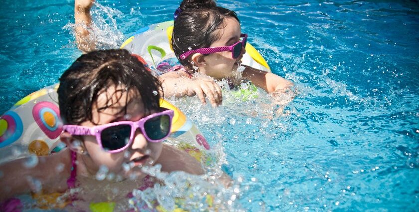 Two children splashing with joy in the resort pool, creating wonderful memories.