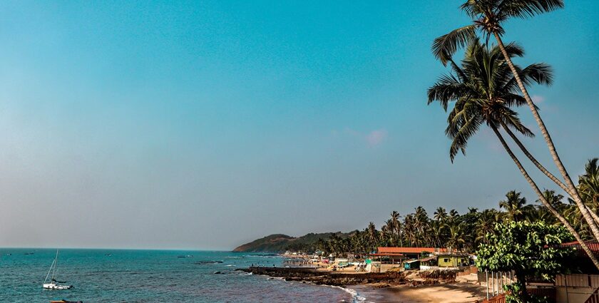 A scenic vista of cobalt-blue waters and golden sands decked with small houses and trees.