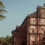 A glimpse of an iconic church adorned with shades of red and surrounded by people.