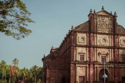 A glimpse of an iconic church adorned with shades of red and surrounded by people.