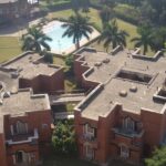 An aerial picture of a hotel in Panchkula with a garden and swimming pool in front