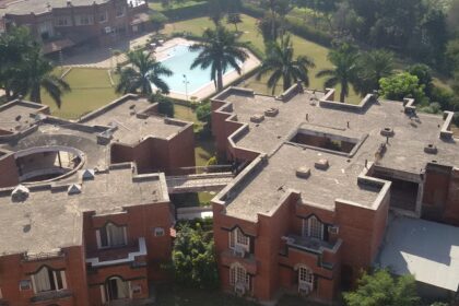 An aerial picture of a hotel in Panchkula with a garden and swimming pool in front