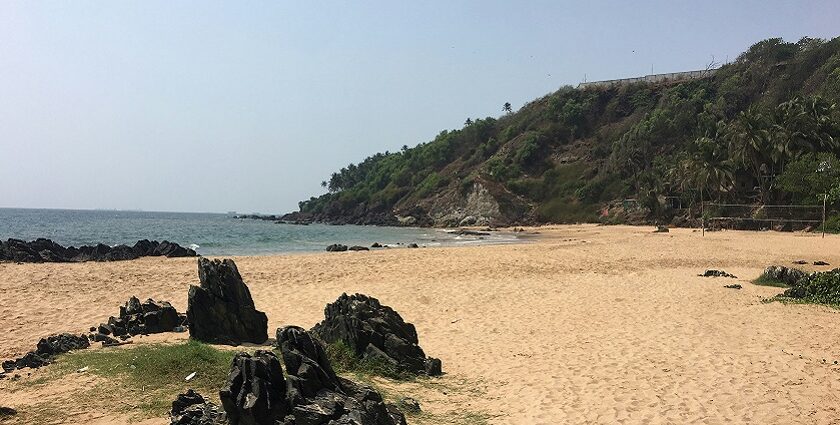 A breathtaking view of a turquoise water body with large and small rocks on the shore.