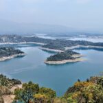 A bird’s eye view of the rolling hills decked with dense forests and waters of the region.