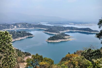 A bird’s eye view of the rolling hills decked with dense forests and waters of the region.