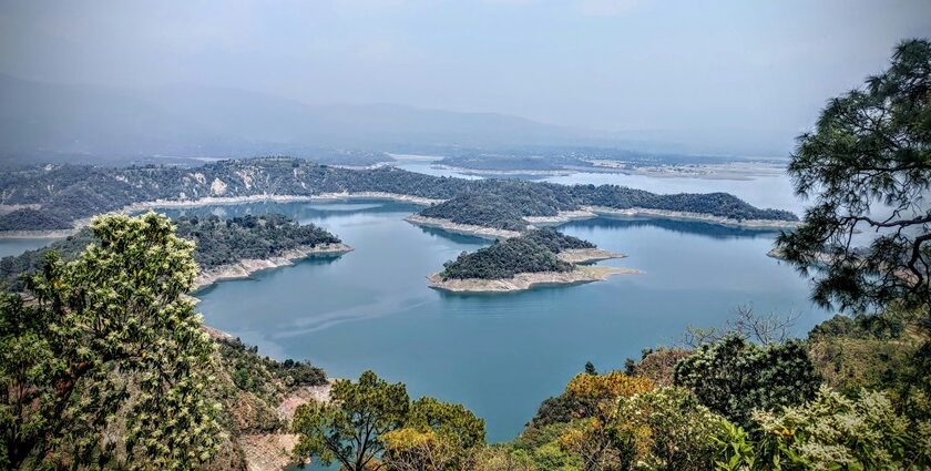 A bird’s eye view of the rolling hills decked with dense forests and waters of the region.