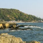 A picture of a beach with an island visible in the background