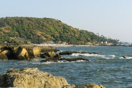 A picture of a beach with an island visible in the background