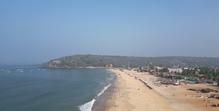 An aerial picture of a beach in Goa with an island visible in the background