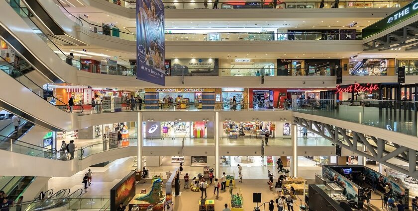 Spacious and modern shopping mall in Malaysia with glass windows and sleek architecture.