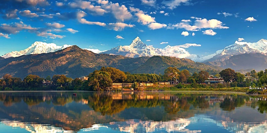 A beautiful picture taken at Pokhara valley with a reflection of the mountains in the waterbody