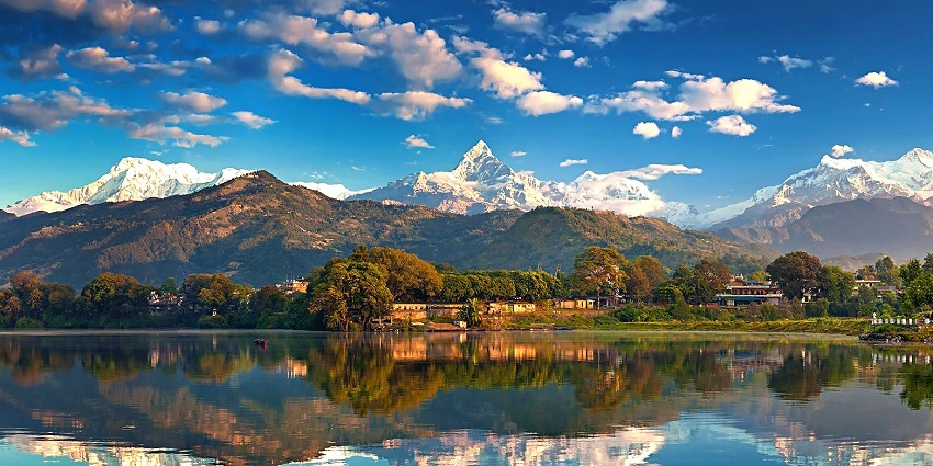 A beautiful picture taken at Pokhara valley with a reflection of the mountains in the waterbody