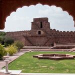 A view of a fort elegantly nestled on the lush green sprawling lands of Rajasthan.